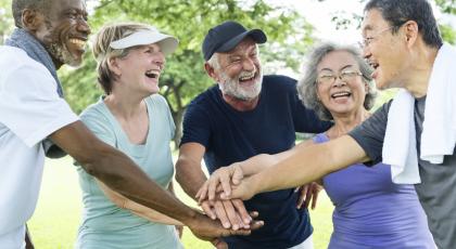 Older people clasping their hands together