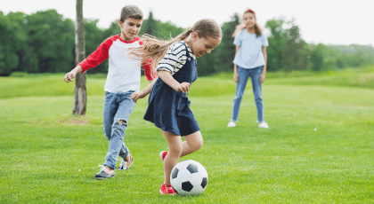 Children playing football outside