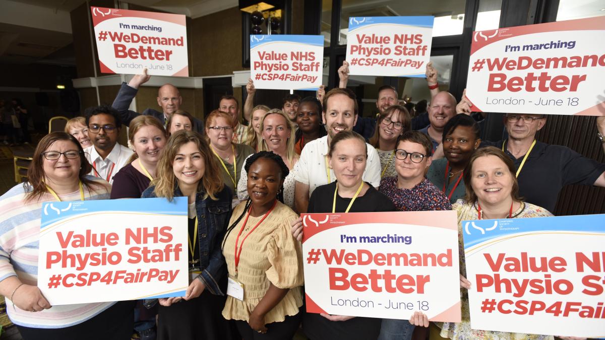 CSP delegates at Annual Representatives Conference hold banners promoting a fair pay rise for NHS staff