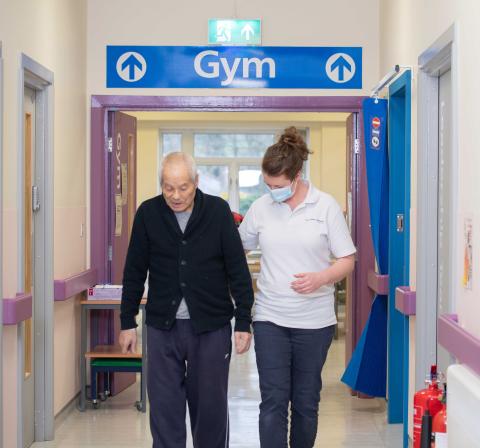 Patient and physio in hospital corridor